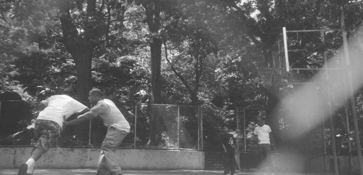Black and white photograph of street basketball in motion
